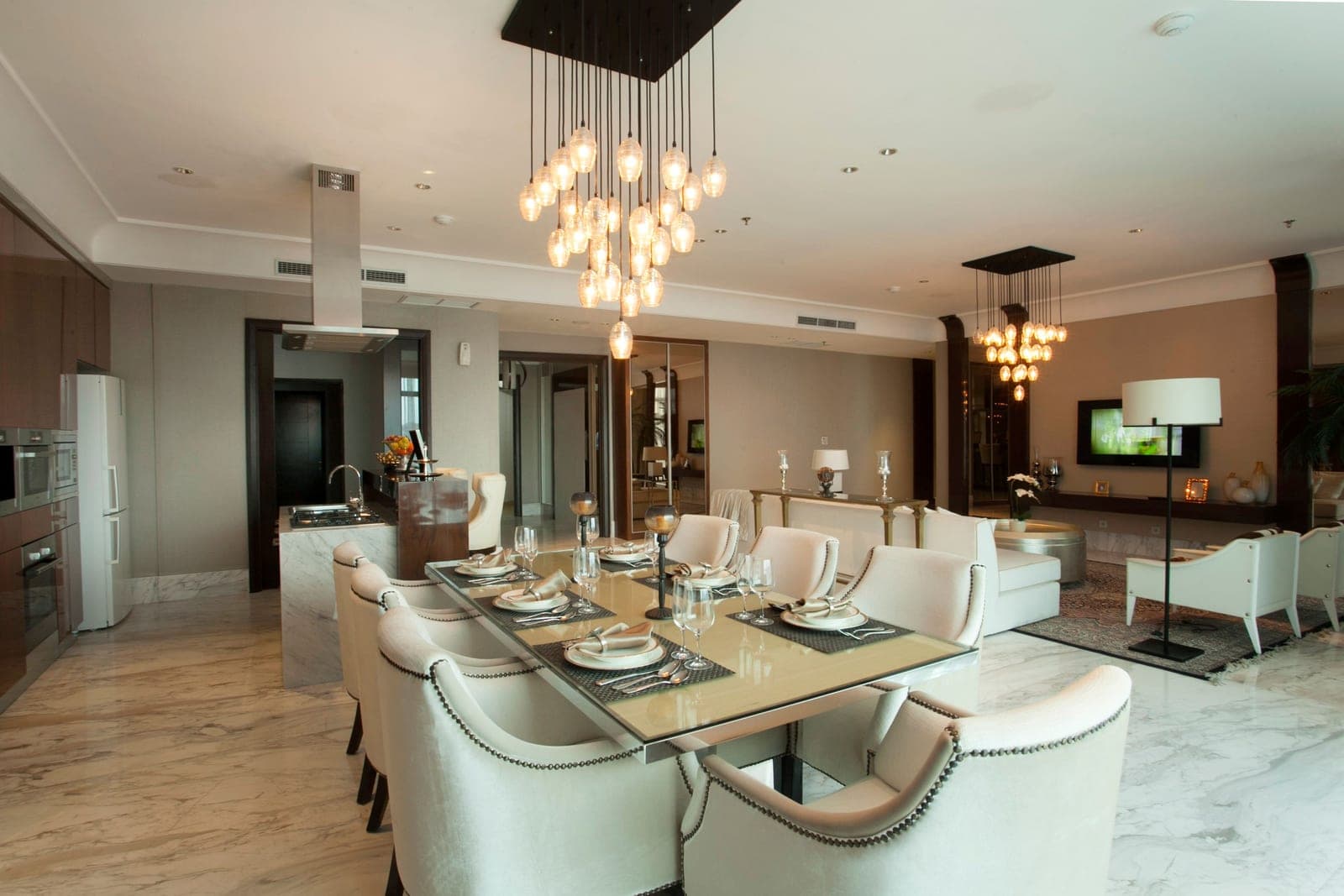 An open-plan living and dining space in warm neutral tones