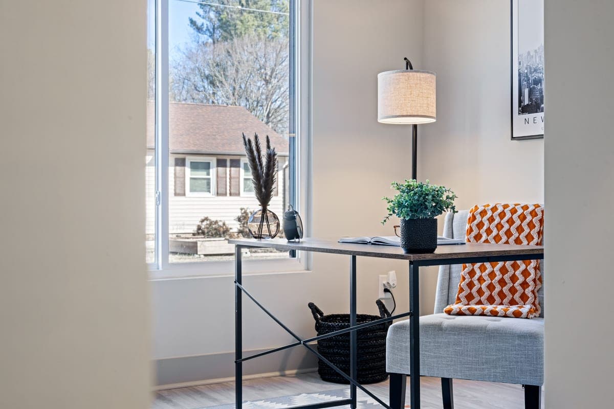 A home-office desk and chair in a warm workspace