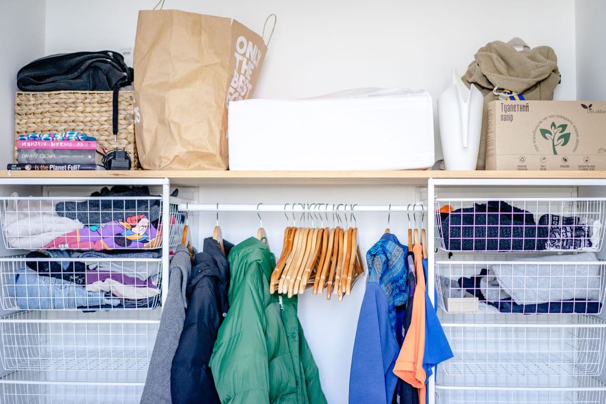 An organized closet with storage bins and baskets