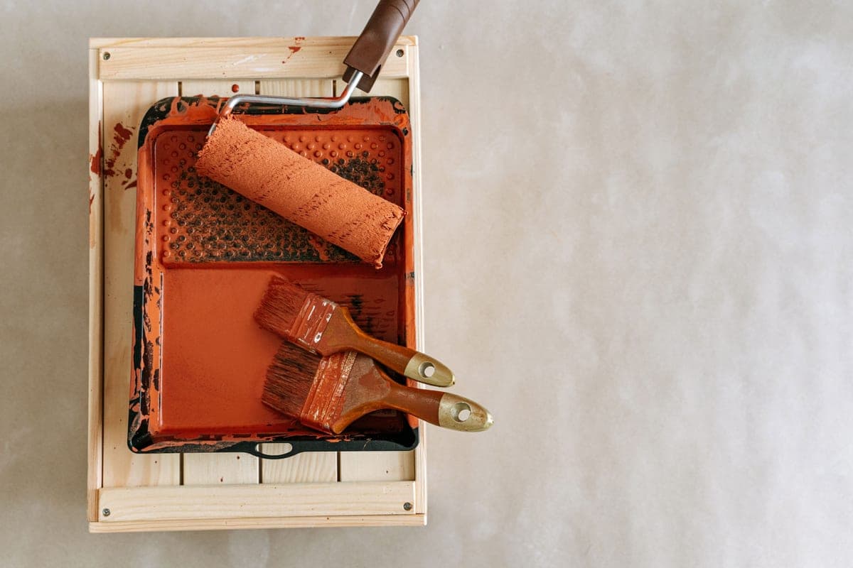 Painting a dresser with a brush during a DIY project