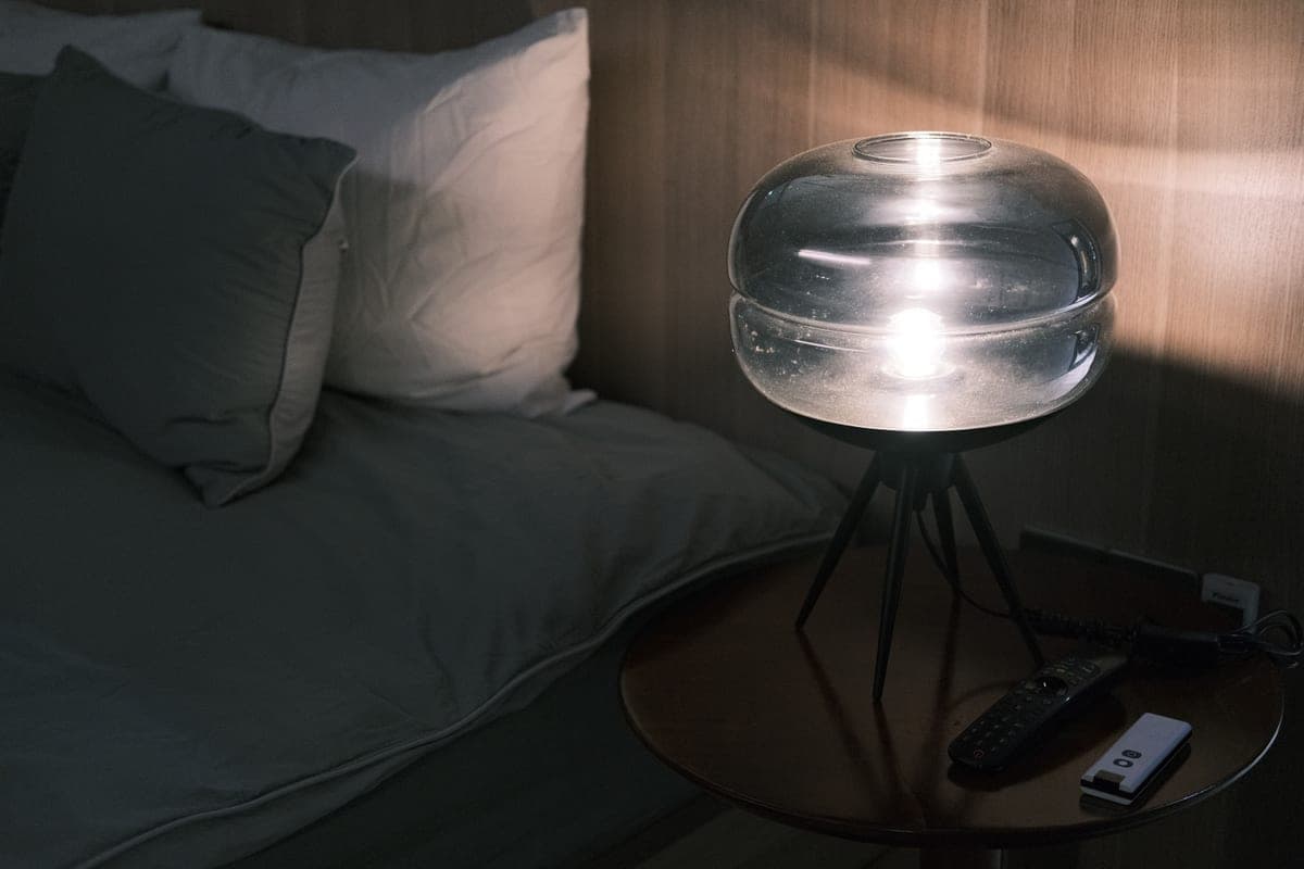 A table lamp casting warm light on a side table